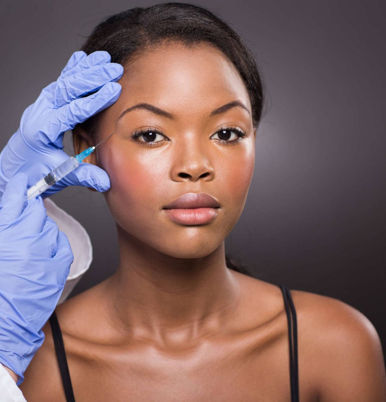 Cosmetic Surgeon Injecting African American Girl Face